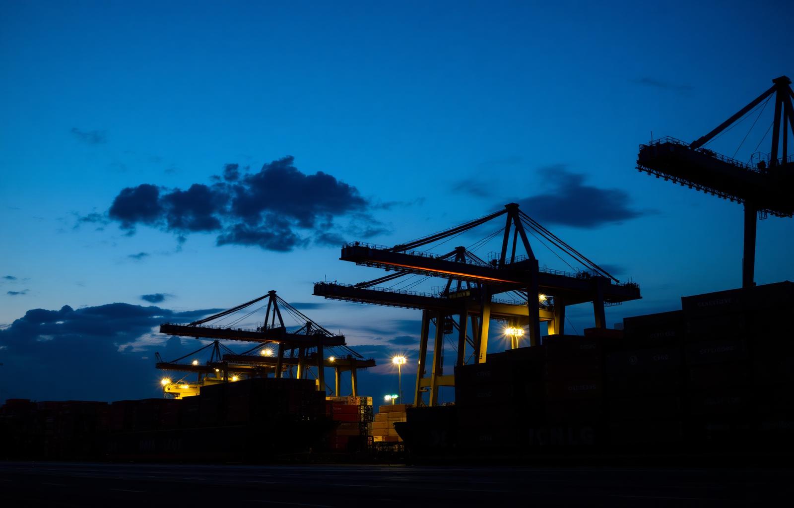 Colombo port at dusk with shipping containers and gantry cranes